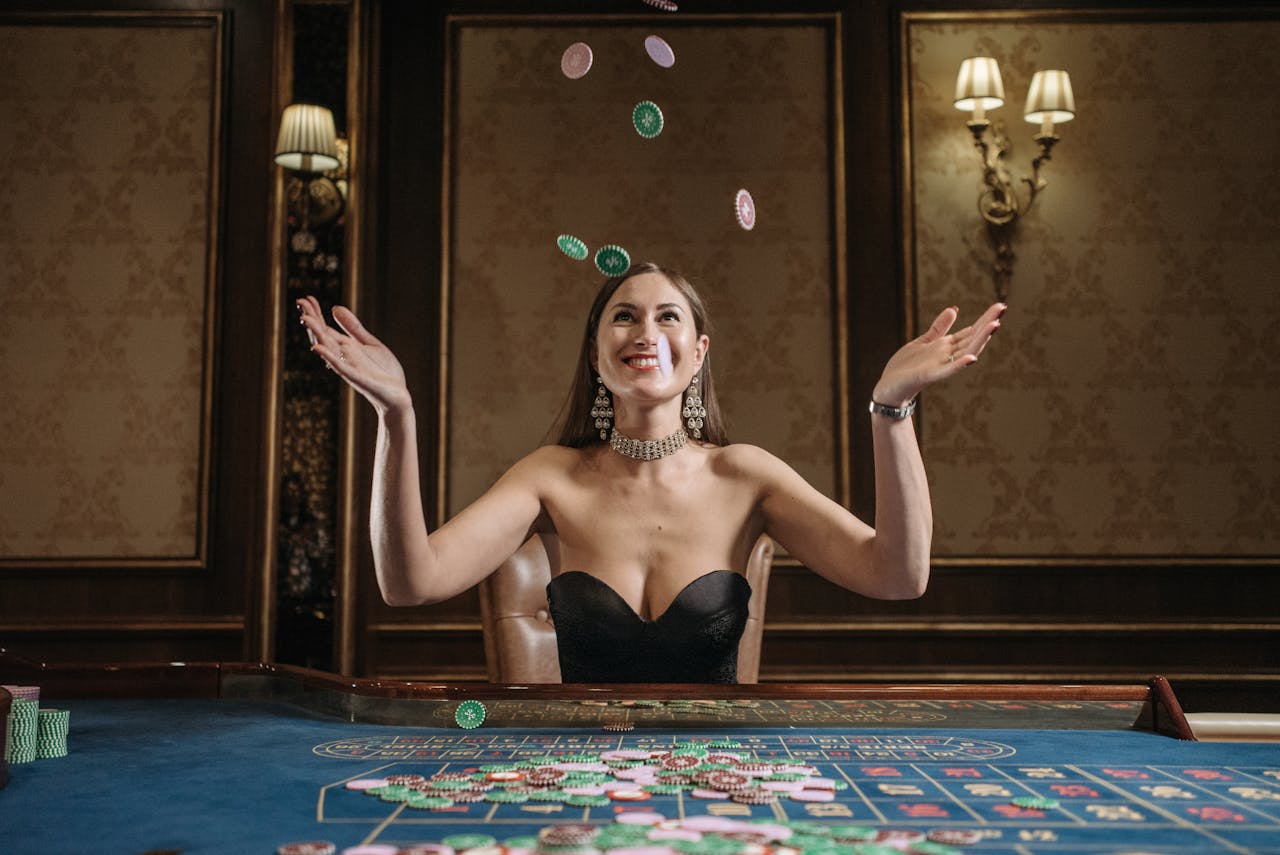 iWin88 official malaysia A smiling woman tosses casino chips up in an elegant gaming room, exuding joy.